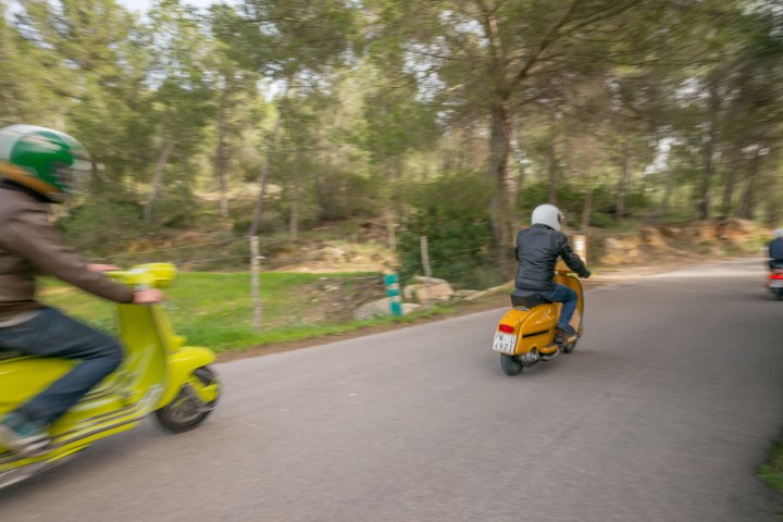 Men driving 2 vintage lambrettas