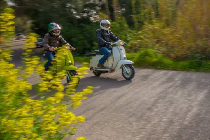 Men driving Scooters