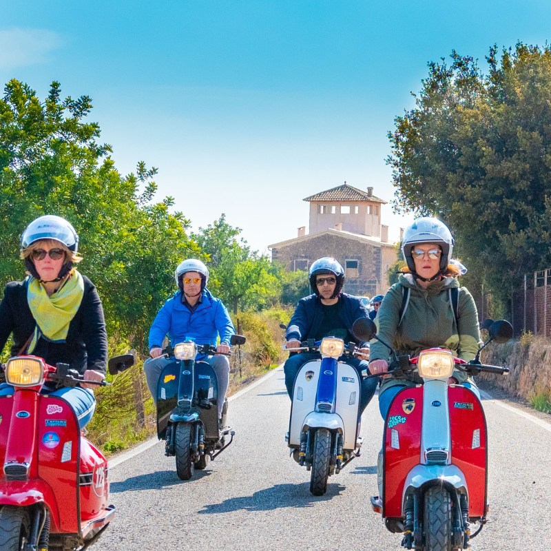 a group of people riding on the back of a motorcycle