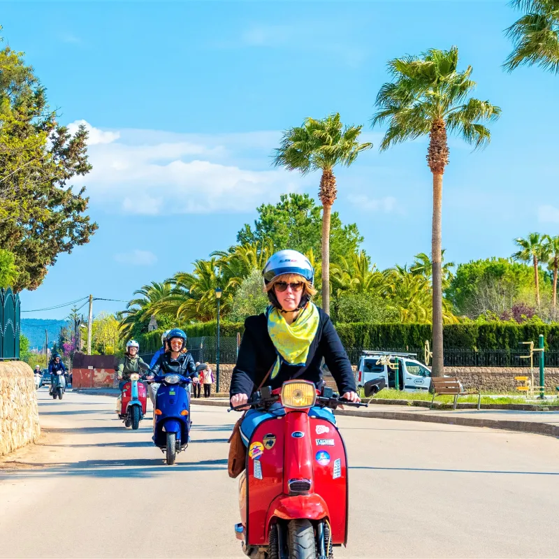 a man riding a motorcycle down a street