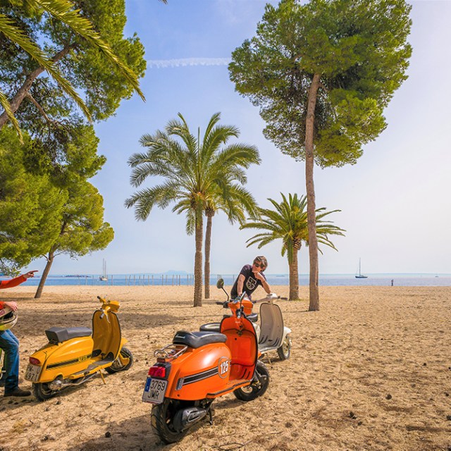 a man riding a motorcycle on a beach