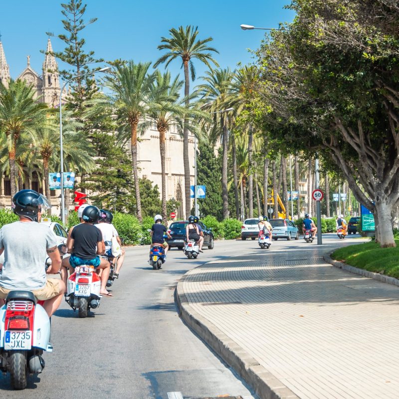 a man riding a motorcycle on a city street